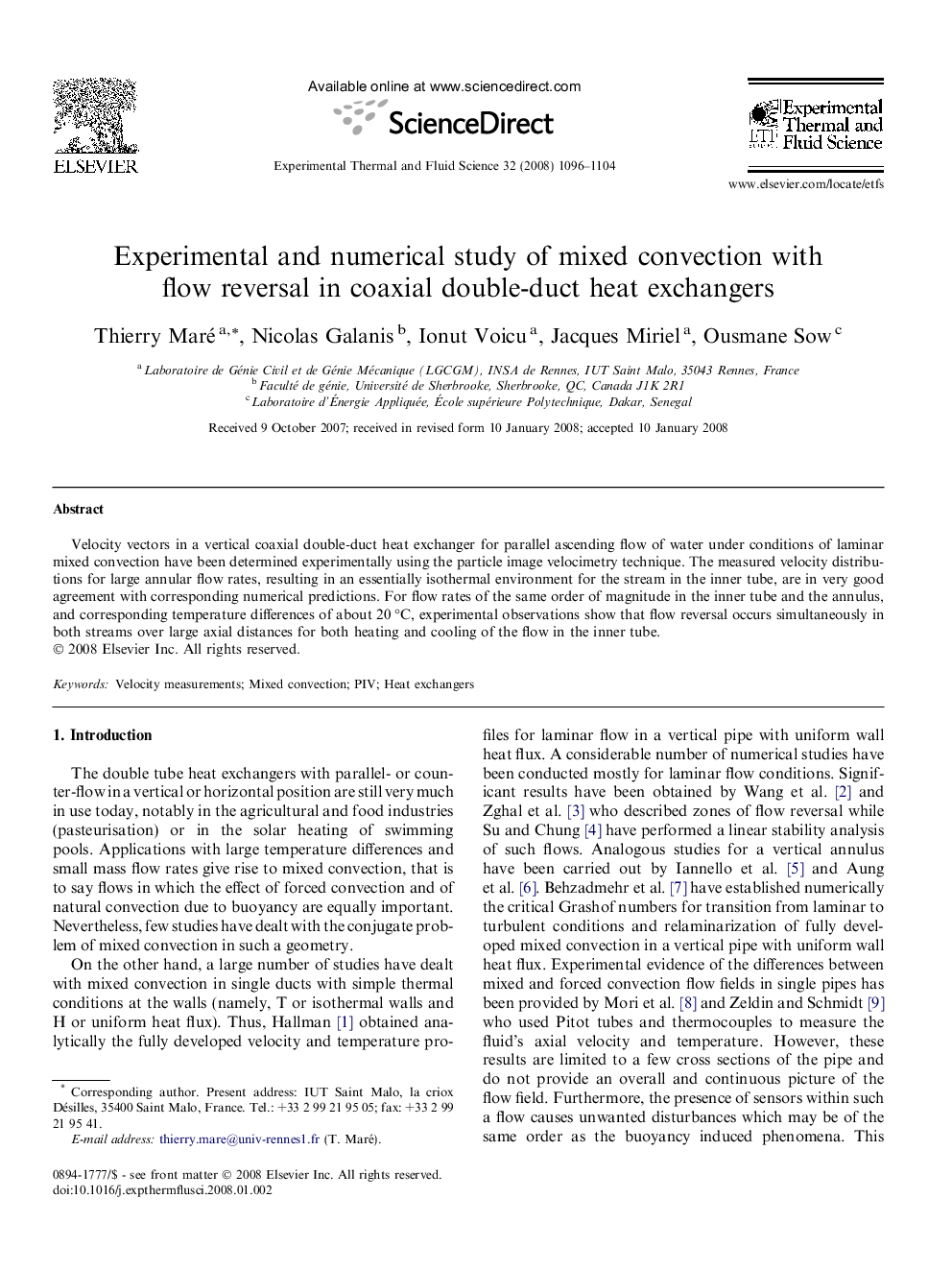 Experimental and numerical study of mixed convection with flow reversal in coaxial double-duct heat exchangers