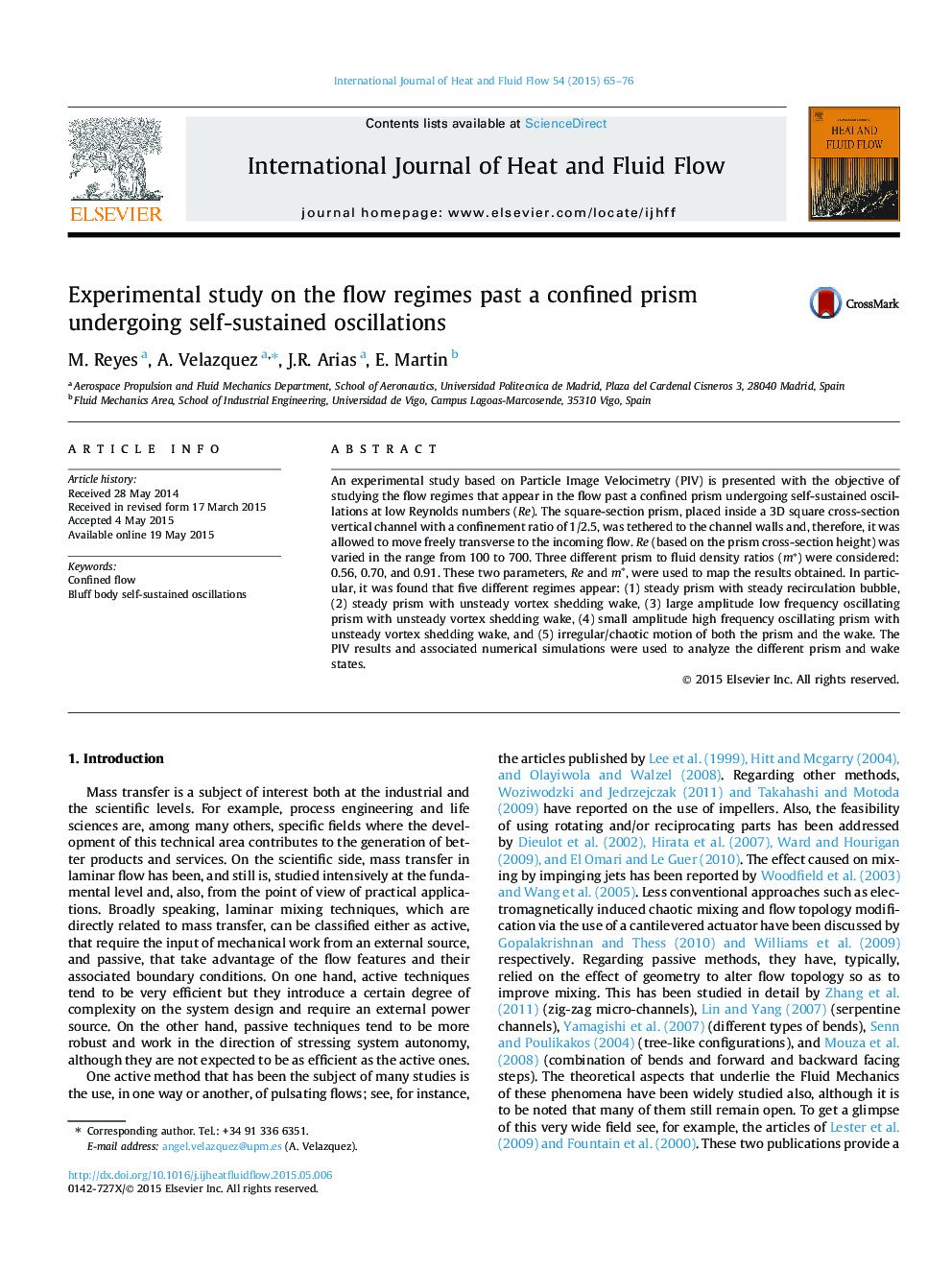 Experimental study on the flow regimes past a confined prism undergoing self-sustained oscillations