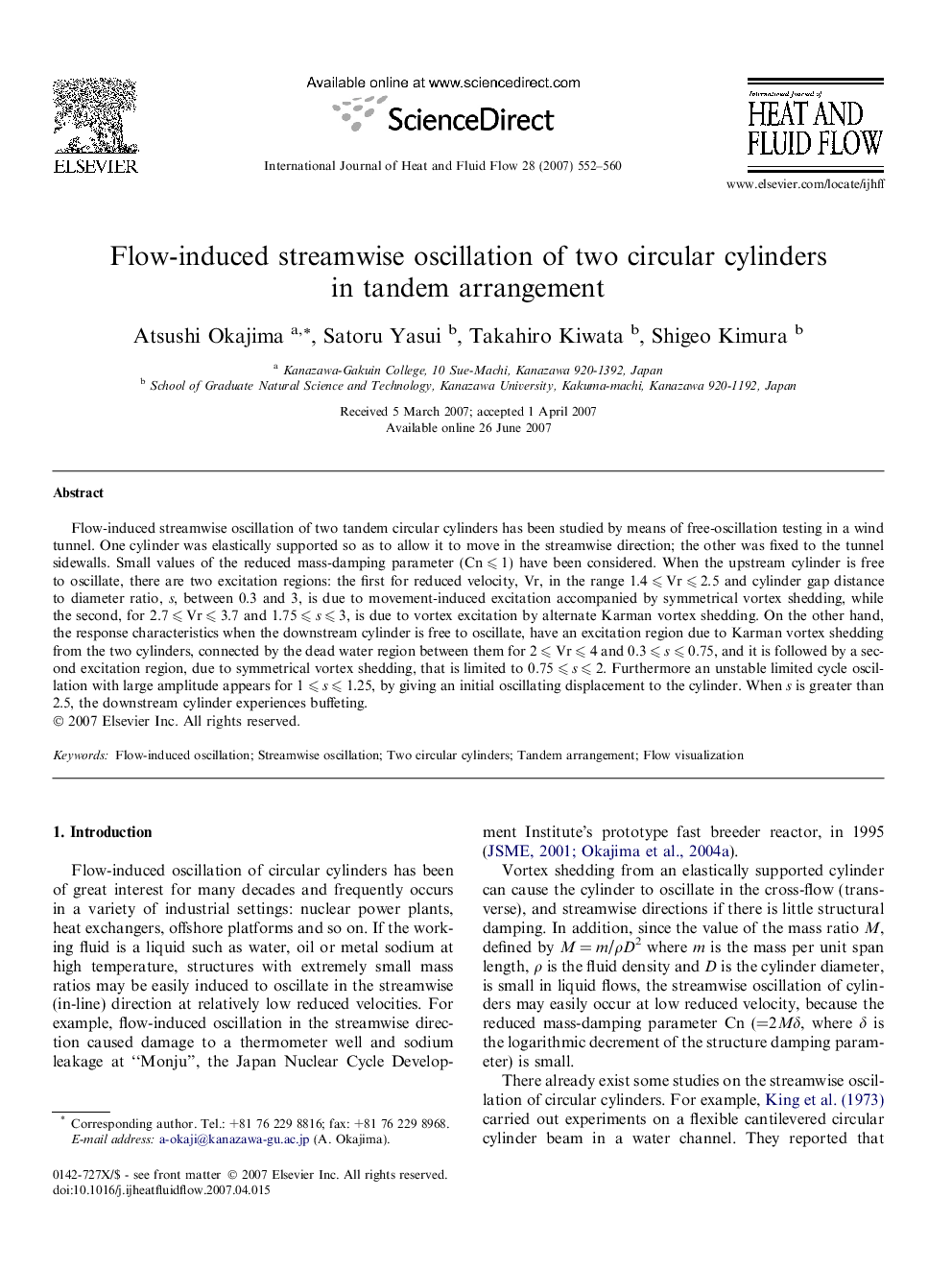 Flow-induced streamwise oscillation of two circular cylinders in tandem arrangement