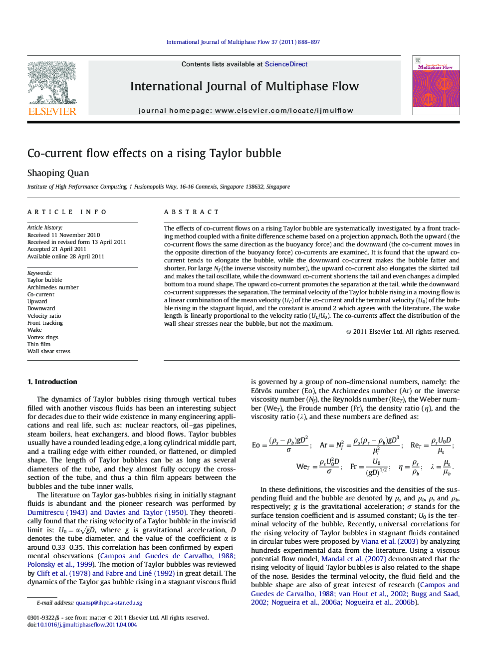 Co-current flow effects on a rising Taylor bubble