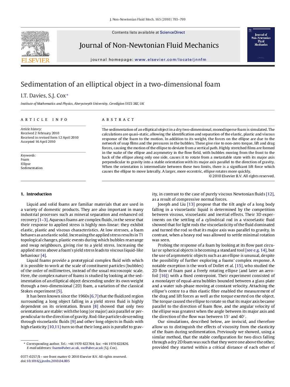 Sedimentation of an elliptical object in a two-dimensional foam