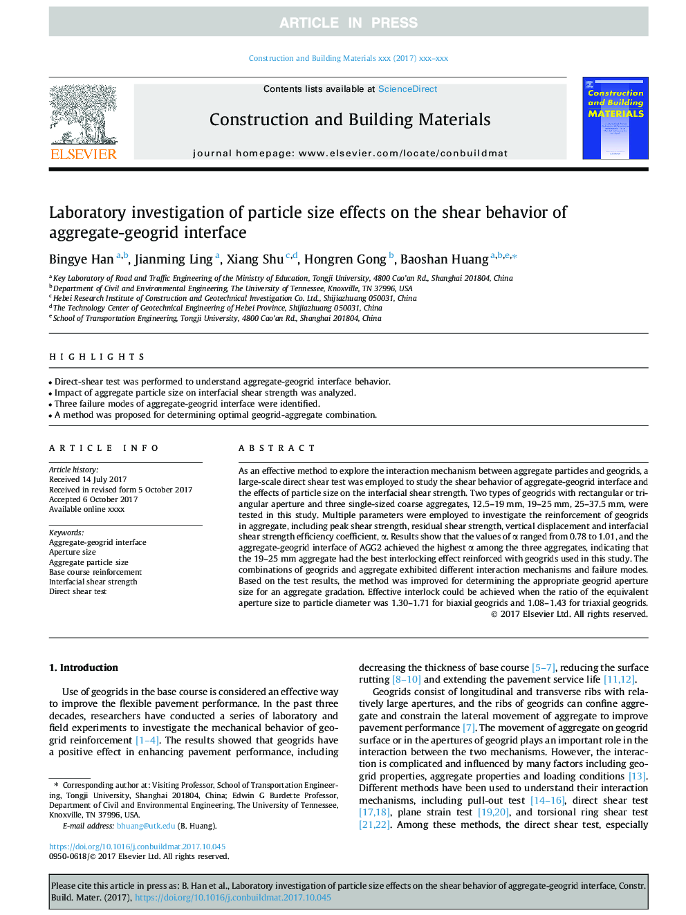 Laboratory investigation of particle size effects on the shear behavior of aggregate-geogrid interface