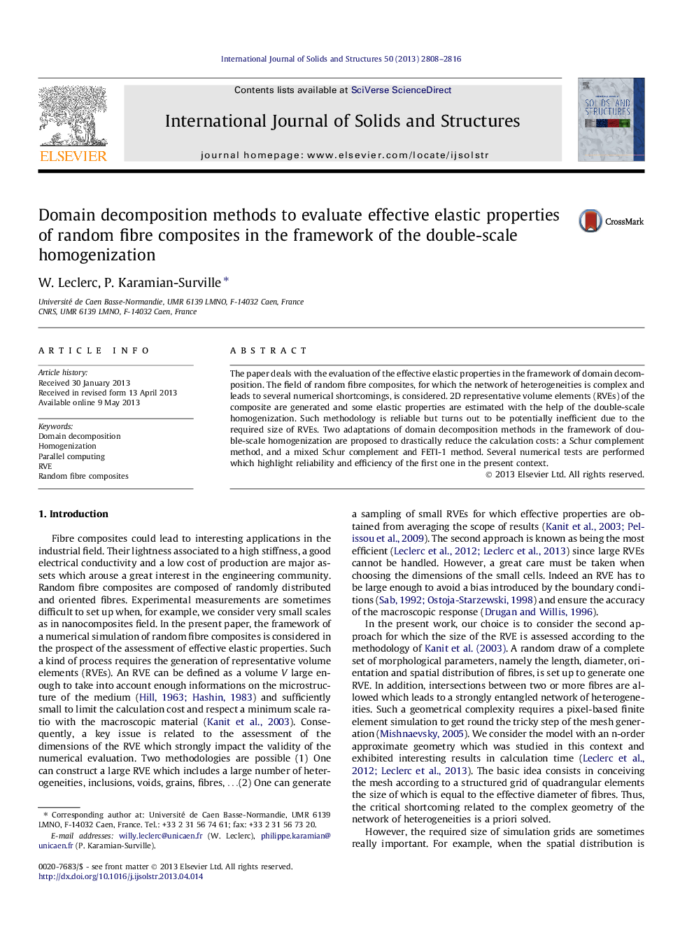 Domain decomposition methods to evaluate effective elastic properties of random fibre composites in the framework of the double-scale homogenization