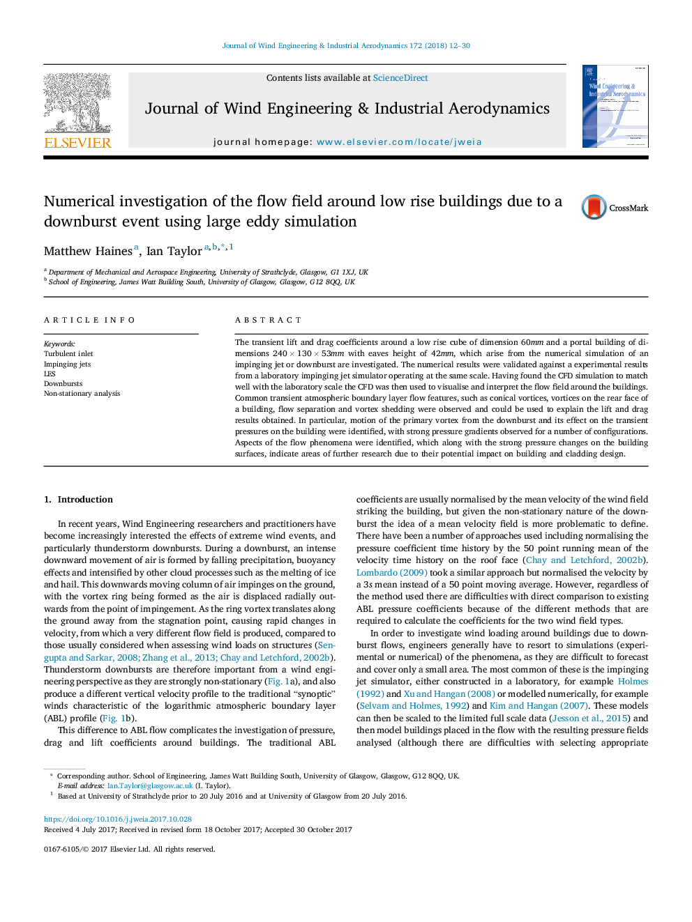 Numerical investigation of the flow field around low rise buildings due to a downburst event using large eddy simulation