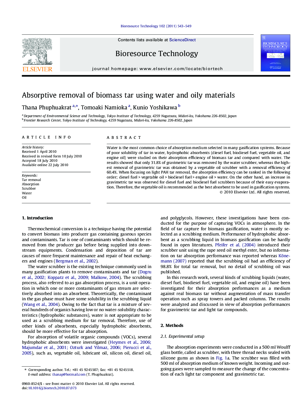 Absorptive removal of biomass tar using water and oily materials