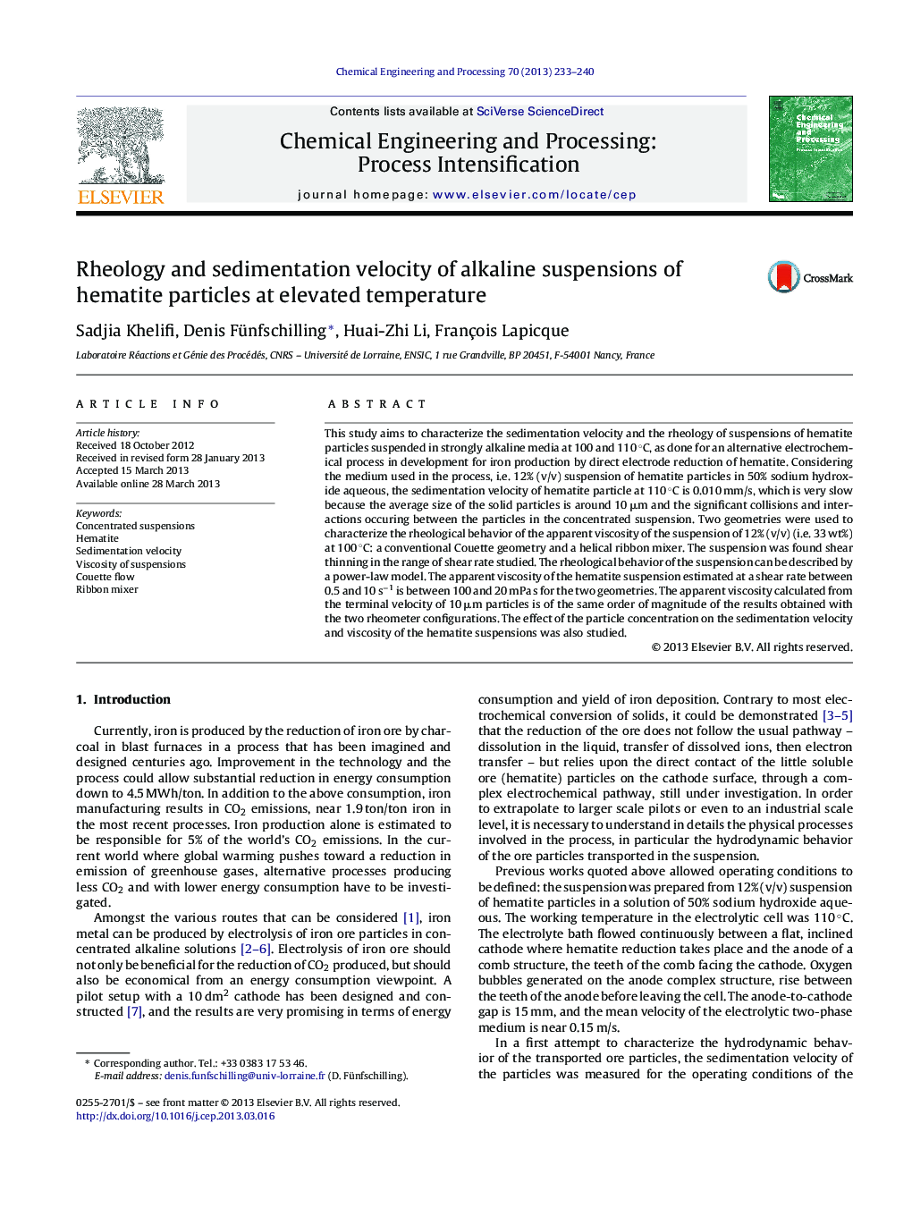 Rheology and sedimentation velocity of alkaline suspensions of hematite particles at elevated temperature