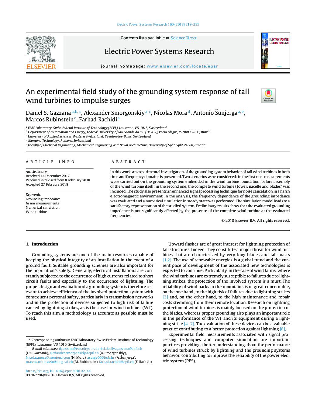 An experimental field study of the grounding system response of tall wind turbines to impulse surges