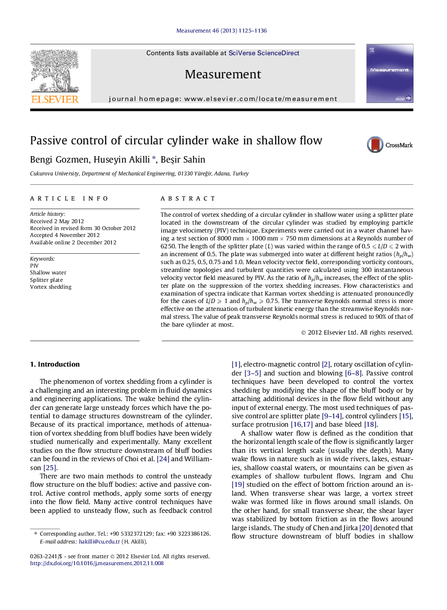 Passive control of circular cylinder wake in shallow flow