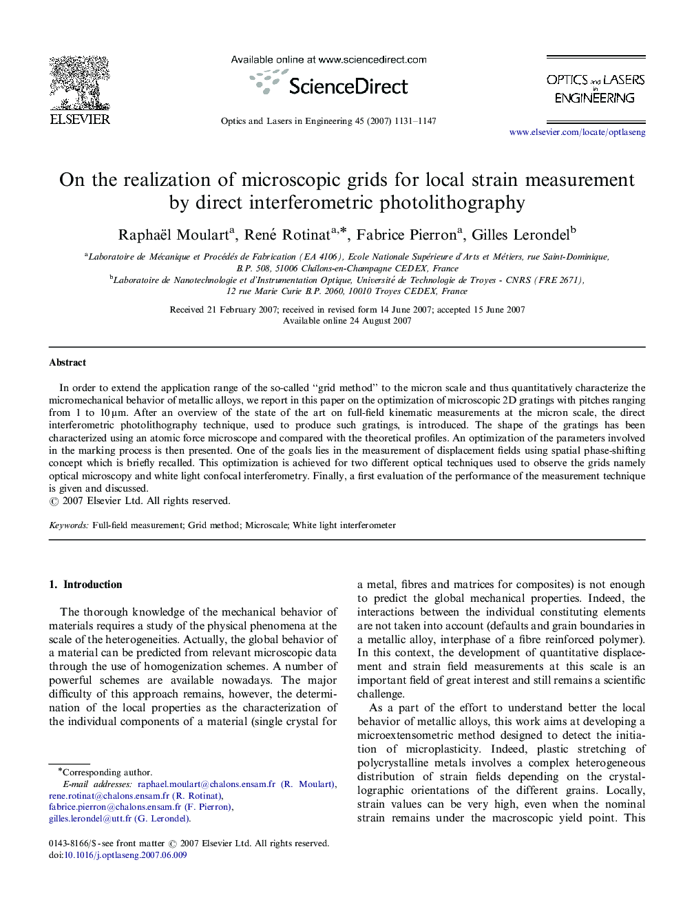 On the realization of microscopic grids for local strain measurement by direct interferometric photolithography