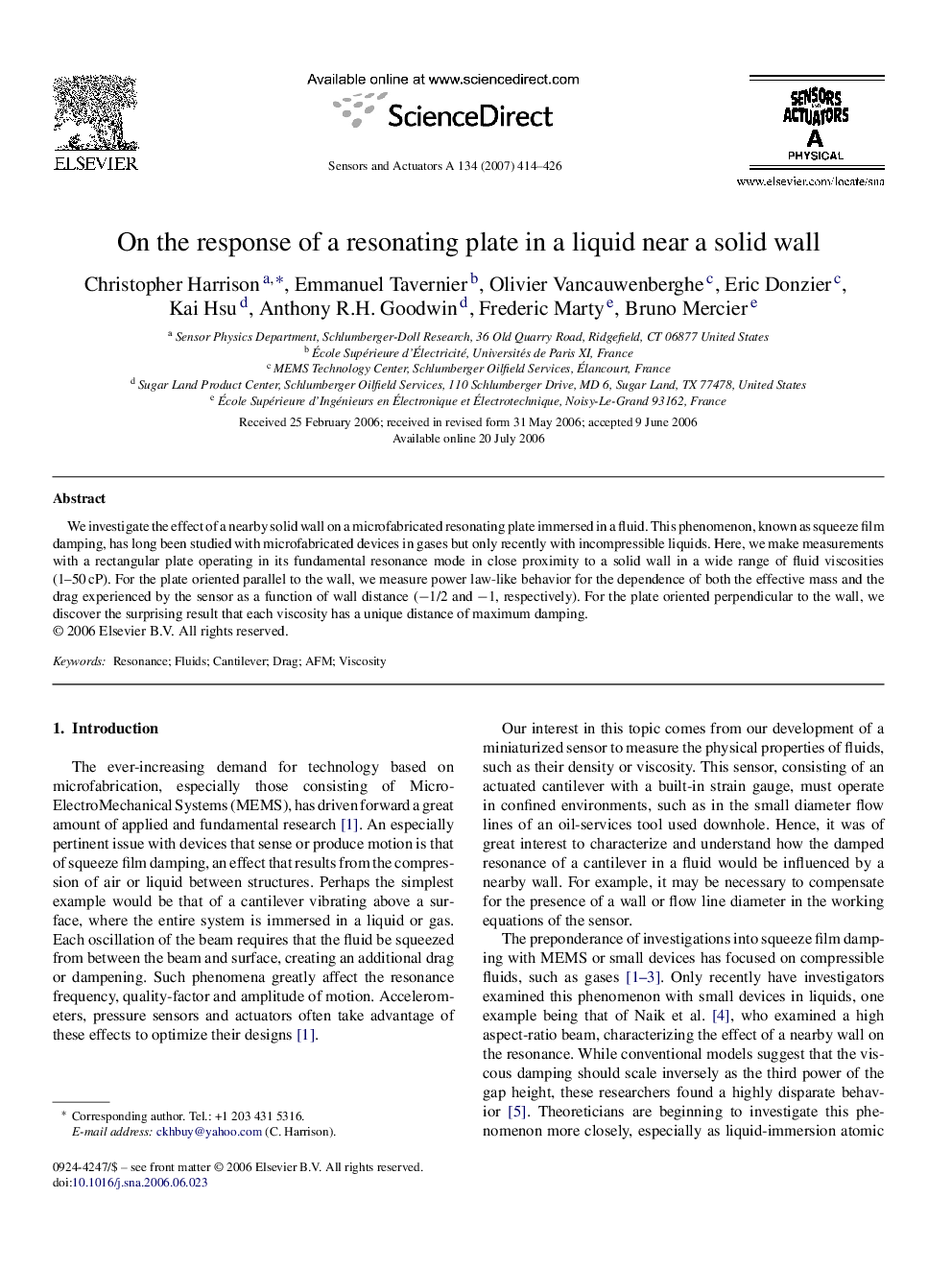 On the response of a resonating plate in a liquid near a solid wall