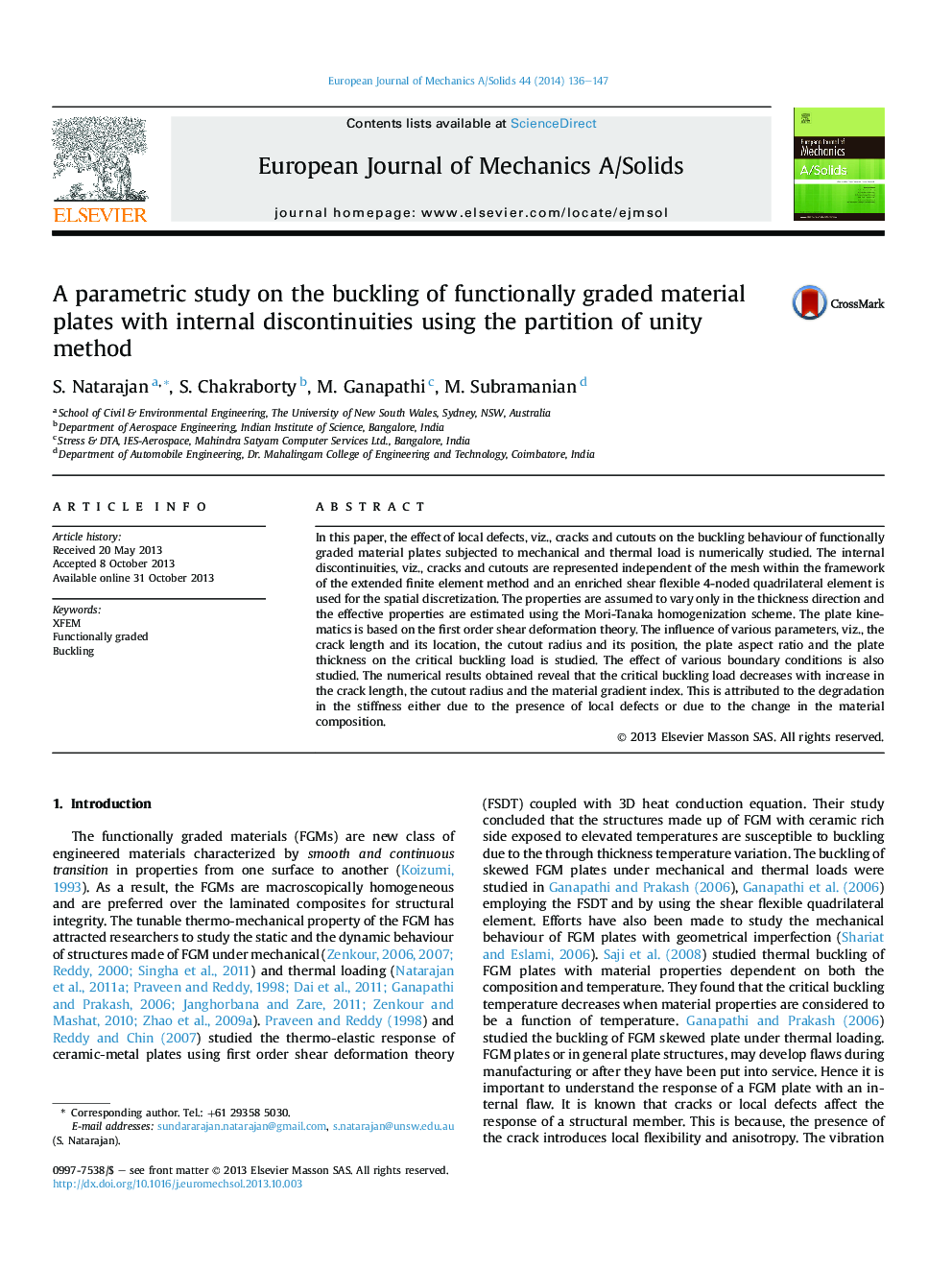 A parametric study on the buckling of functionally graded material plates with internal discontinuities using the partition of unity method