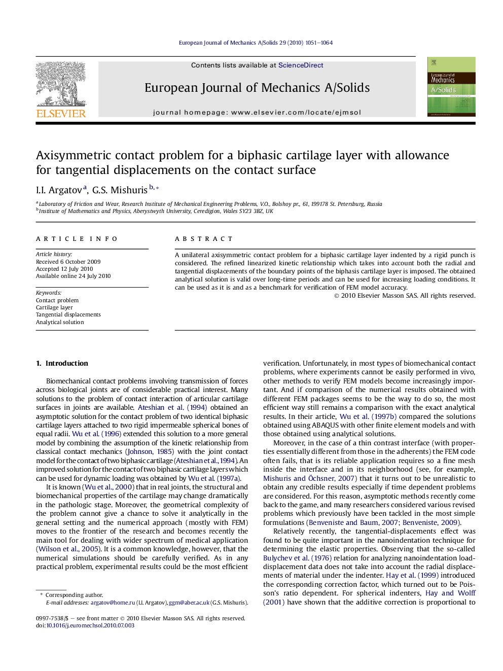 Axisymmetric contact problem for a biphasic cartilage layer with allowance for tangential displacements on the contact surface