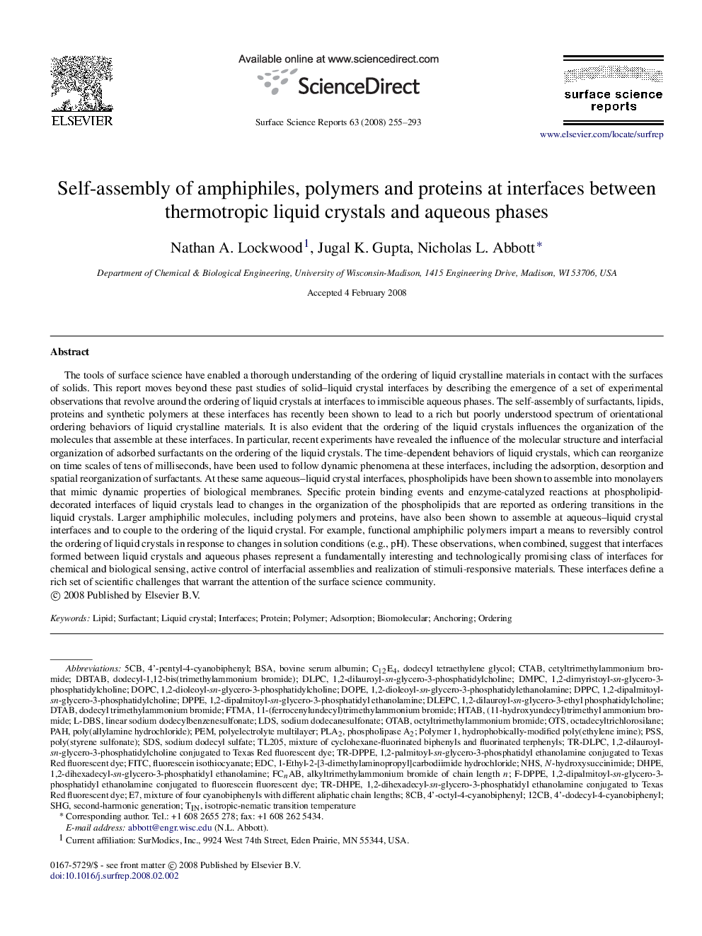 Self-assembly of amphiphiles, polymers and proteins at interfaces between thermotropic liquid crystals and aqueous phases