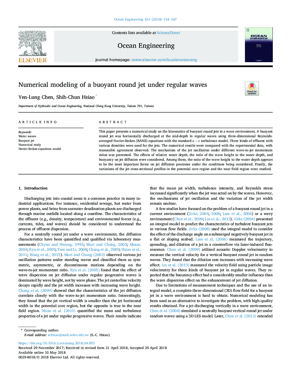 Numerical modeling of a buoyant round jet under regular waves