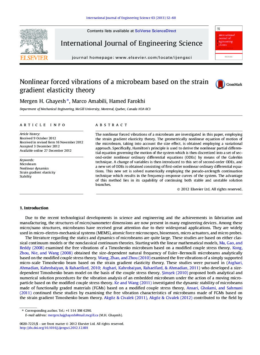 Nonlinear forced vibrations of a microbeam based on the strain gradient elasticity theory
