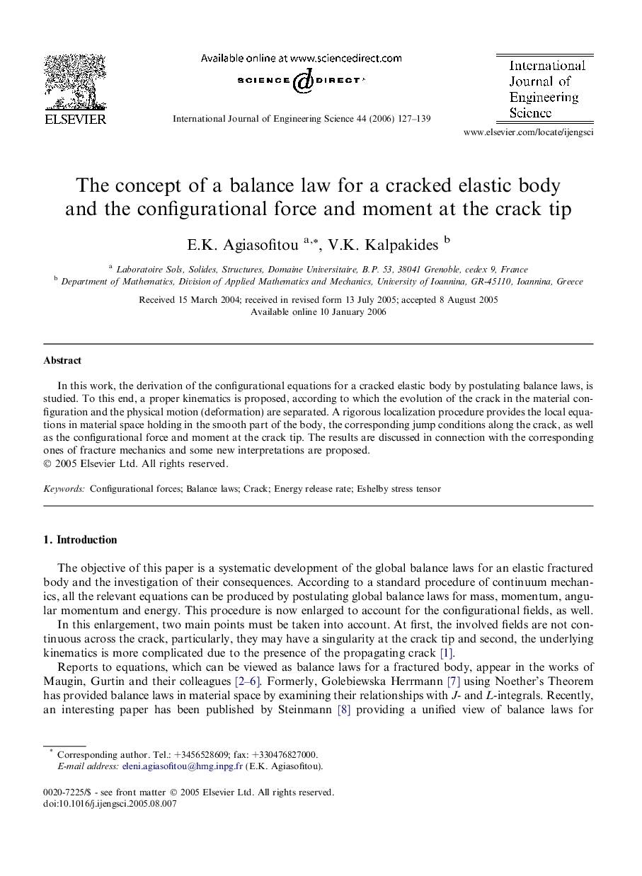 The concept of a balance law for a cracked elastic body and the configurational force and moment at the crack tip