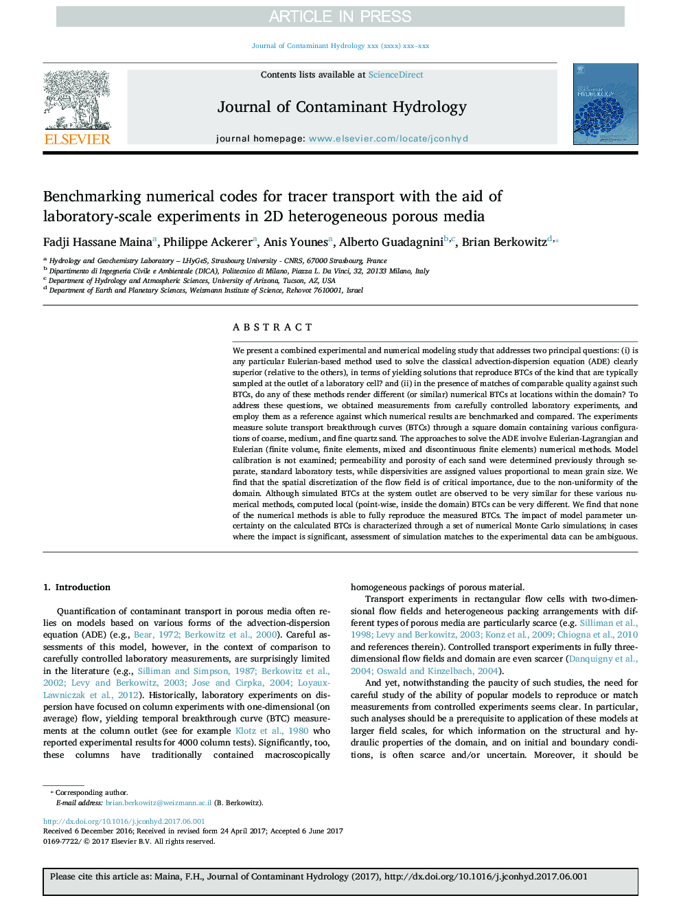 Benchmarking numerical codes for tracer transport with the aid of laboratory-scale experiments in 2D heterogeneous porous media