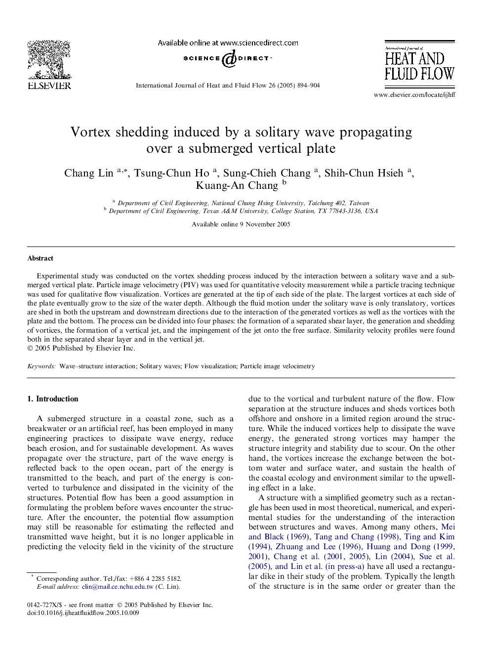 Vortex shedding induced by a solitary wave propagating over a submerged vertical plate